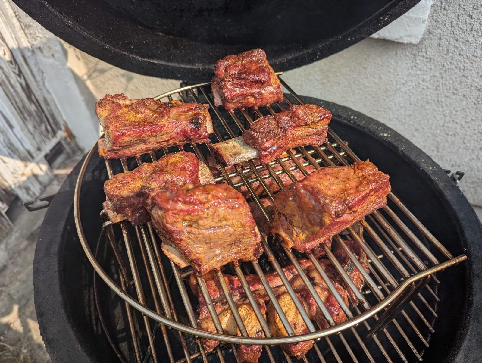 Racks of ribs resting inside a smoker